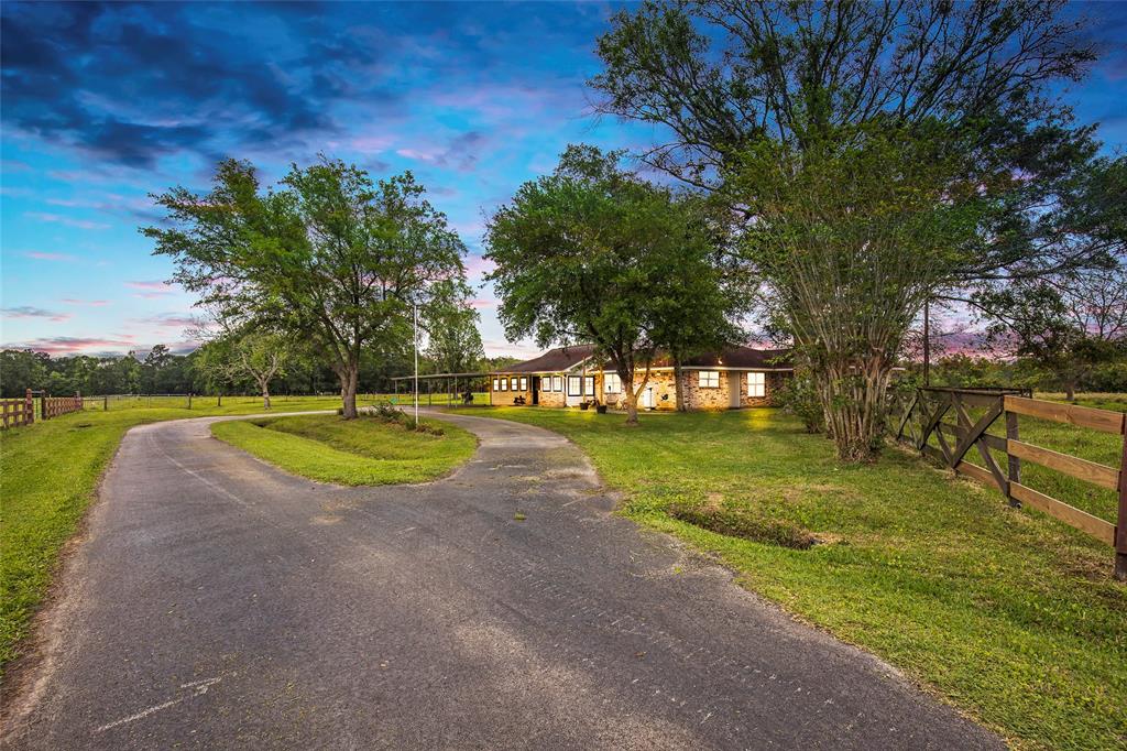 1654 County Road 301 Dayton, Texas Home is located down a quiet county road in Tarkington ISD. The 4 bedroom home was built in 1975 and has been recently remodeled with hardwood flooring, granite countertops in the kitchen and more! The main wing of the home has the master bedroom as well as 2 additional bedrooms, and through the 29X14 sunroom breezeway you enter the additional wing, featuring a utility room with enough space for cabinets or extra refrigerator, bathroom, and flex room! This are would make for a great mother-in-law suite! Outside the home is beautifully cleared 13.76 acres of fenced pasture land surrounding the spacious yard area that features mature shade trees and plenty of space for outdoor activities.
Property is fully fenced and cross-fenced, has 2 ponds, includes a 25x40 pole barn with 15ft lean-to’s on both sides, full cattle working facilities, and a 10x12 horse/livestock stall. Livestock water is supplied by an air-lift well with a 500 gallon holding tank.