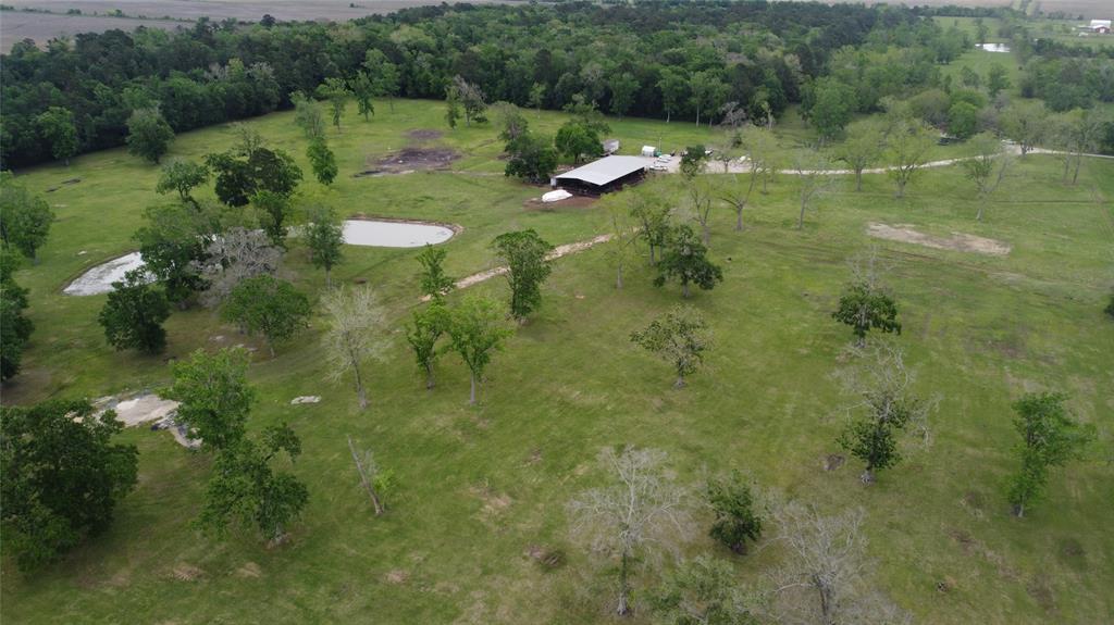474 County Rd 6244 Dayton, Texas Country at its finest only 3 miles from Toll Rd 99. 75.94 acres nestled at the end of the road. Fenced and cross fenced for all of your livestock needs. Huge plantation Oaks and Native Pecans. Modest 1483 sq ft, 4Bdr/2bath farm house. Stocked lake with Catfish and perch. 60x114 Main barn with 10x24 office, 2 heated/ac controlled rooms, 10x20 feed room, wash rack and multiple pipe pens. 14x78 Trailer cover off side of barn. Additional 15x40 barn in back pasture. Improved pasture on most of the property. Private water well. Crushed concrete and limestone driveways. If you want a turnkey working farm, Come Build your Dream Home !!!!