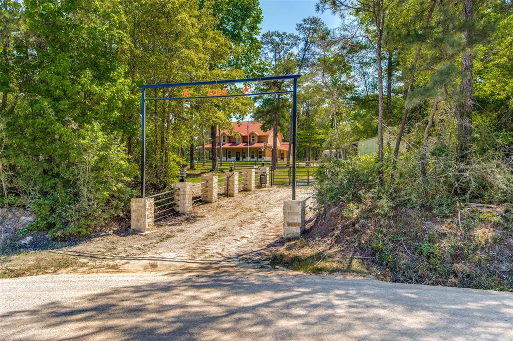 1254 Rocky Creek Road Livingston, Texas Amazing 30 acre property located in Livingston Texas. The property borders the waterfront of Rocky Creek with access to main lake. Home has 7 bedrooms with 4 Baths, Open concept living area with four bedrooms down, three up, including bunk room and game room. Property has many amenities such as a Metal Barn, Storage Building, Sports Court, Swimming Pool, Fire Pit and a Stocked Pond. Pond is irrigated and has it's own dedicated well so that it is always full. There are many trails through the property that allows for exploring and hunting on the property. This home is being sold completely furnished with the items that are in the home at time of the showing. This is just a short drive from Houston, but far enough away to be your own private oasis. Don't miss out on this rare opportunity, and schedule your showing today.