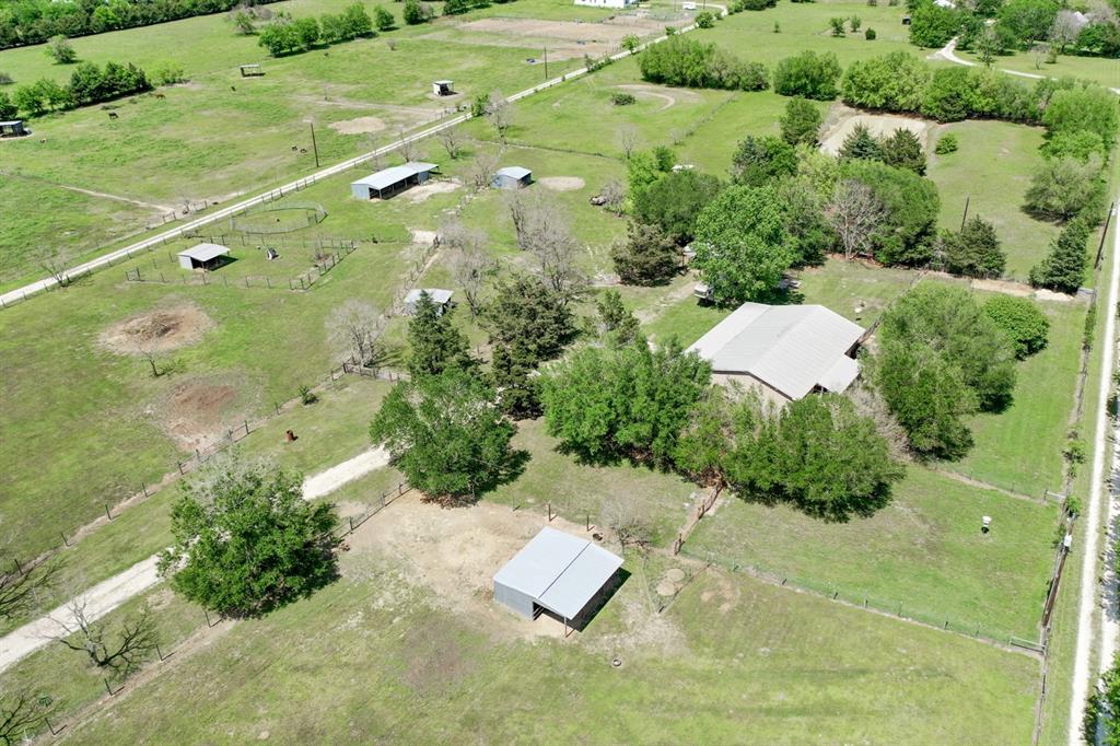 5756 Dick Elliott Road Bryan, Texas 5 Acre Hobby Farm for Sale in Bryan, TX. Bring your horses and 4-H projects and call this country gem home! The 3 bed/2 bath, 1,700 sq/ft brick rancher features metal roof, enclosed sun room patio, attached garage, extra deep covered front patio, new laminate flooring, new paint, granite in the kitchen & lots of cabinets for storage. Anchored by this charming house, the layout of the property is incredibly functional offering 7 paddocks, all with loafing sheds and water, 3 stall shed row barn w/ enclosed feed room, small air conditioned shop with ample covered storage on two sides, 3 dog yards, electric solar powered front gate entry and much more. Welcome to the country life!