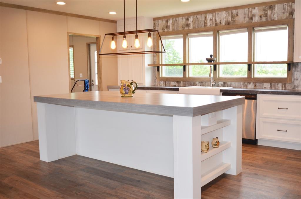 120 Road 5212 Cleveland, Texas Welcome to this lovely 2019 Doublewide M-Home, MH6 situated on a cul-de-sac. This Lovely almost new home has 3 bedrooms, two and a half bath. Hardwood flooring throughout the home with carpet in the bedrooms. The kitchen has an open concept with trendy White cabinetry in the kitchen, the Island is long and spacious. Modern light fixtures, and lots of deep drawers for all those pots and pans. Home comes with mini-blinds. HVAC/ROOF/Tankless Water Heater only used for 1 year. Sellers purchased the M-Home in 2020. Lot is more than half an acre. Refrigerator, Washer & Dryer and Microwave included in this awesome almost new M-Home, the only thing missing out here is "You"