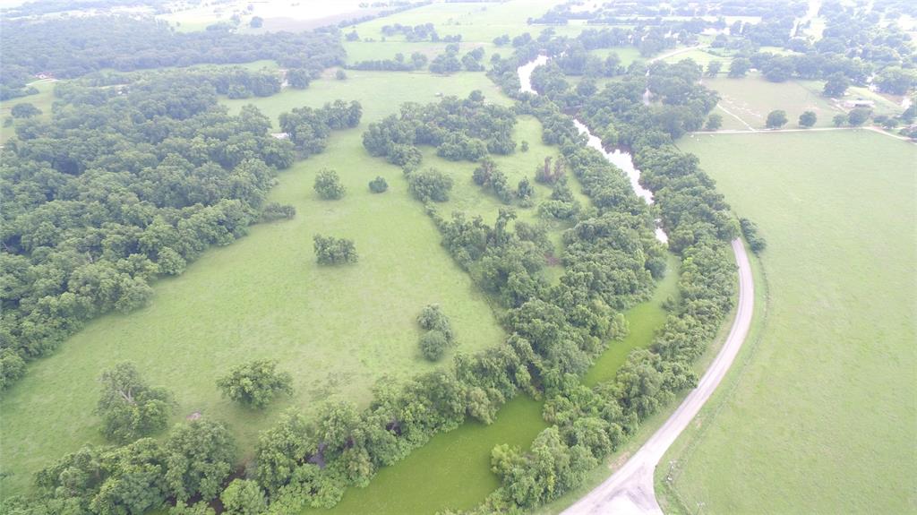 Beautiful wooded tract along Old Caney Road south of Wharton with 3,000' of Caney Creek meandering through property.  Large native pecan trees and large live oaks cover large portion with open and scattered trees covering the balance.  Fenced, electricity, water well and older 800 sf barn.