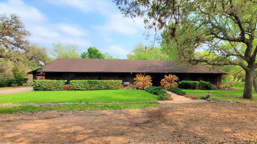 17195 Fm 682 Yoakum, Texas This is a rare listing and won't last long at this price! Right at 42 acres of beautiful oak trees with a large brick home situated in the back so you have the privacy you are looking for. Because there is a creek as one border of the property you have bountiful wildlife! The home is in the flood zone but has had a berm engineered by the corps of engineers around it to protect it from floodwaters. The home is a custom-built home with many custom features including custom cabinets with 2 pantries, and double ovens. The round fireplace in the center of the huge living space has 2 openings for wood-burning fires and one stove. The 2 car garage has a storage room with a full bath and a sauna! There are cattle pens with a barn with a cement floor and lean to. There is an additional 1800sf barn with 2/3 cement floor and 3 stalls. Seller owns minerals and is offering 20% to the buyer with an acceptable offer. Schedule your tour now to see this fabulous place!