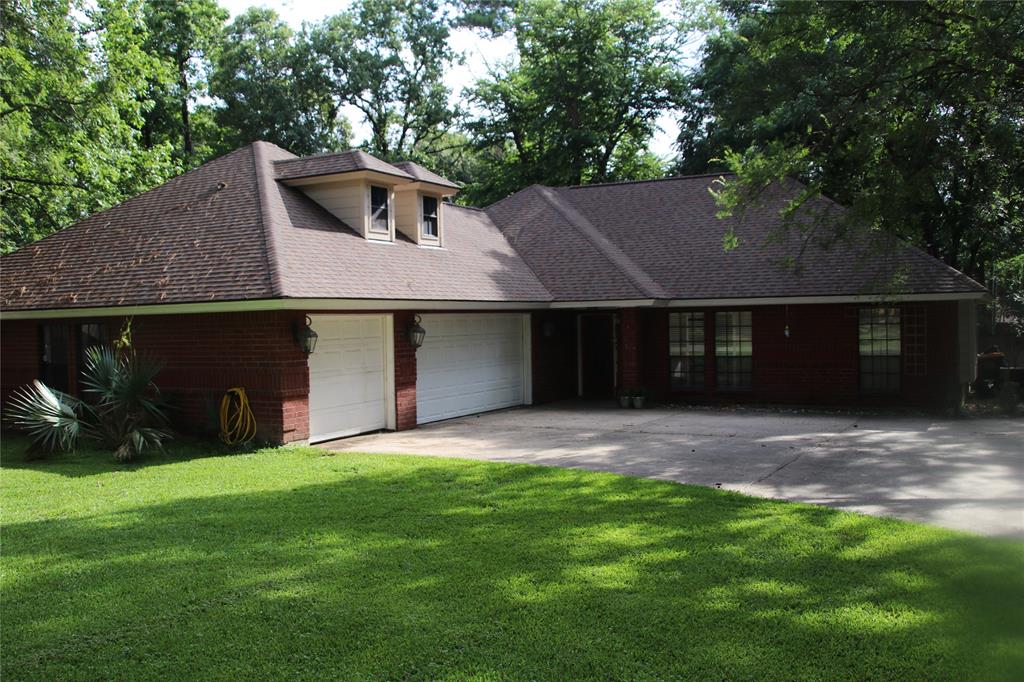2417 Canter Lane Conroe, Texas WOW Six car garage with this beautiful custom one story in Carriage Hills subdivision. Two Master Suites with full baths. Two gas log fireplaces. Additional bedroom and study with full bath. Stainless kitchen appliances, granite counters, 5 burner gas cook top. Refrigerator included. High ceilings. Ceiling fans throughout, bronze fixtures, recent interior neutral paint, wood look tile (Tile throughout). Large back yard deck & privacy fence. Workshop and extra storage. Carriage Hills is known as The Woodlands' best kept secret! Quiet neighborhood with 1/2 acre+ lots, large shade trees.Two miles from I 45, in highly acclaimed CISD. Close to The Woodlands amenities, shopping. Subdivision pool, tennis, basketball. Come home, settle and relax. Owner is Listing Agent.