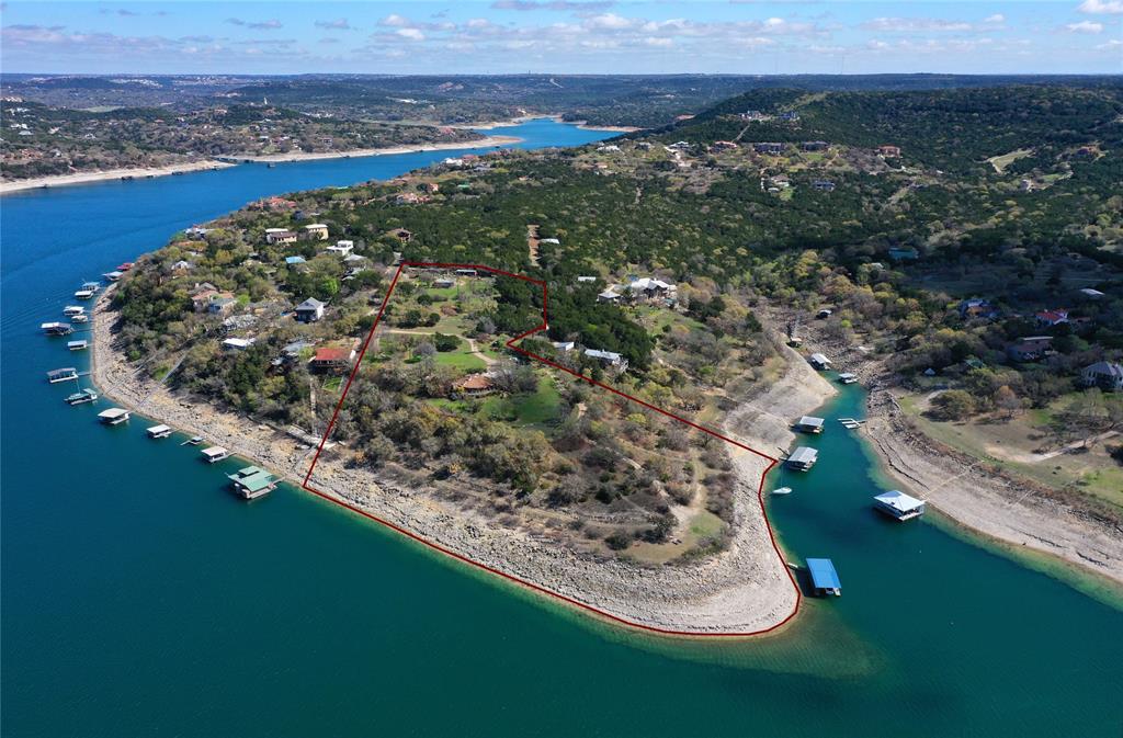 Spectacular 10 acre deep waterfront peninsula on Lake Travis avail. w/993 ft of Waterfront footage. Minimal floodplain, incredible views. Level huge building site. Easily walk/drive down to waterfront. Waterfront at mouth of Deep cove as well as main body. Nice trees w/3 existing older homes: One 3 bd/2 ba 2,511 sqft per tax records & 1983 build; one 2 bd/1 ba 578 sqft per tax records & 1970 build; one 1 bd/1 ba 250 sqft per tax records & 1983 build. Buyer to verify sqft, homes sold as-is. Minimal value in homes but would make great guest homes or weekend/vacation homes. Located in Volente feeding to excellent schools. 10 min. from 620/2222. Major shopping, restaurants, movie theaters etc. 35 min. to DT Austin & major hotspots. Lake living at its best. Ready for a dream estate, Family compound or potential Development. Seller will NOT consider long due diligence. There's not a better waterfront lot on Lake Travis this close in w/this access, view & usable acreage. Water source is lake.