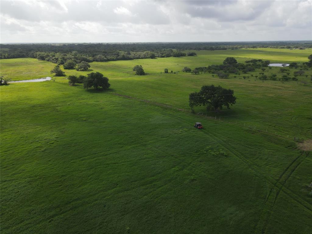 2451 Rappold Road Yoakum, Texas A 102 acre sportsman & rancher's paradise! This property has CD 90160 Hybrid Bermuda grass - a hybrid grass developed by Texas A&M as a specialty grazing, baling, and pasture grass. You will NOT find another property better maintained, fertilized, brush controlled, & weed controlled. This amazing acreage has beautiful HUGE oaks and pecans throughout. There is an amazing pond - perfect for fishing, wildlife & livestock. There is an abundance of deer, wild turkey & other beautiful wildlife. There is a new (2020) metal building with 50x50 insulated shop area equipped with three 14x14 electric sectional rollup doors. Attached is additional roof area making the building 11,250 sqft of under roof space! This property has a 2 bedroom, 1.5 bath older home with a great covered carport & covered porch area - perfect for weekends! There is a great separate 20x42 metal building, which is a perfect "man cave" or deer processing room! This dream acreage has it ALL - one you CANNOT pass up!!