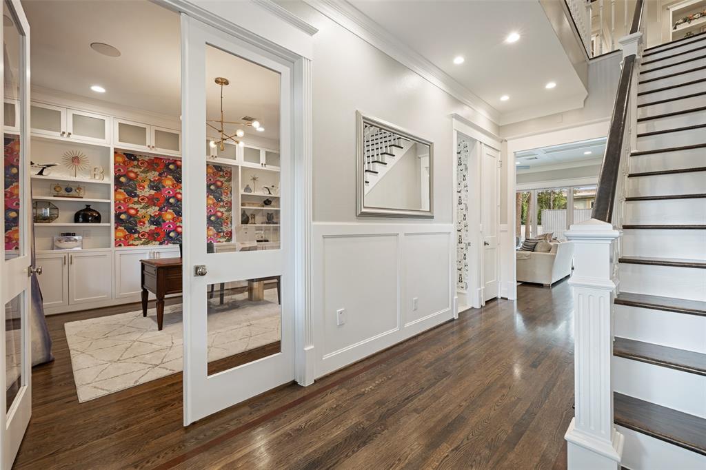 Another photo from the front door. In this frame, you can see many of the millwork details, like the wainscoting in the entryway, glass inlaid doors to the study, and the classically detailed staircase.