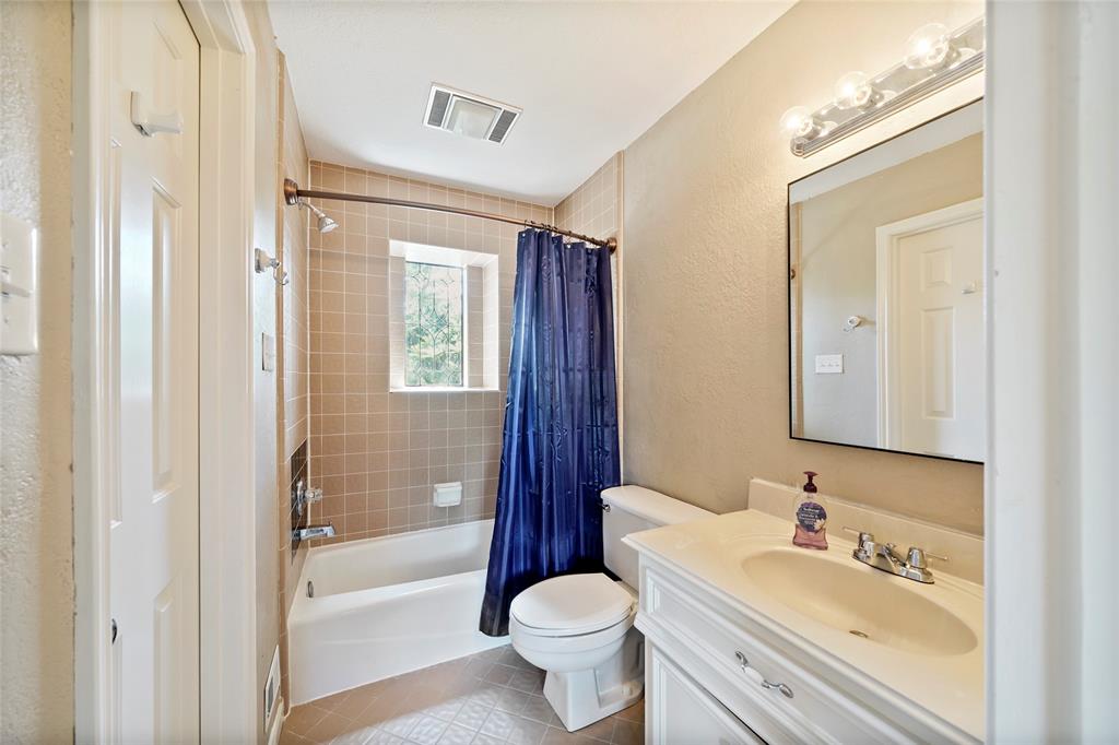 The private secondary bathroom with walk-in closet to the left.