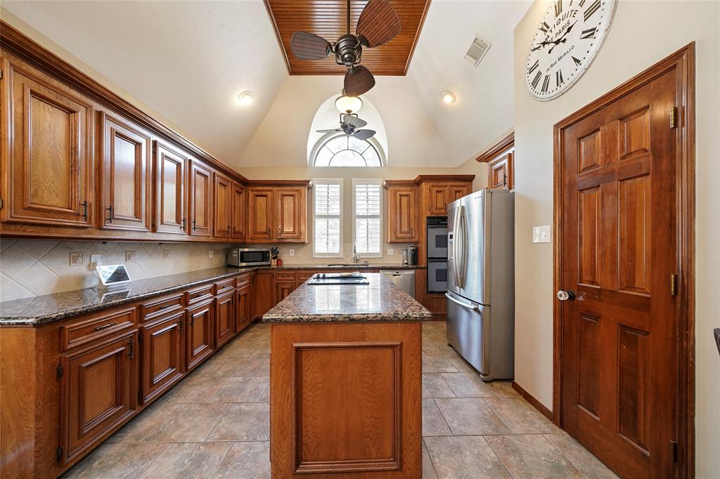 The family chef will love this generously sized kitchen with stainless steel appliances, a 2018 dishwasher, a double oven, center island and granite countertops. The kitchen has views into the living area.
