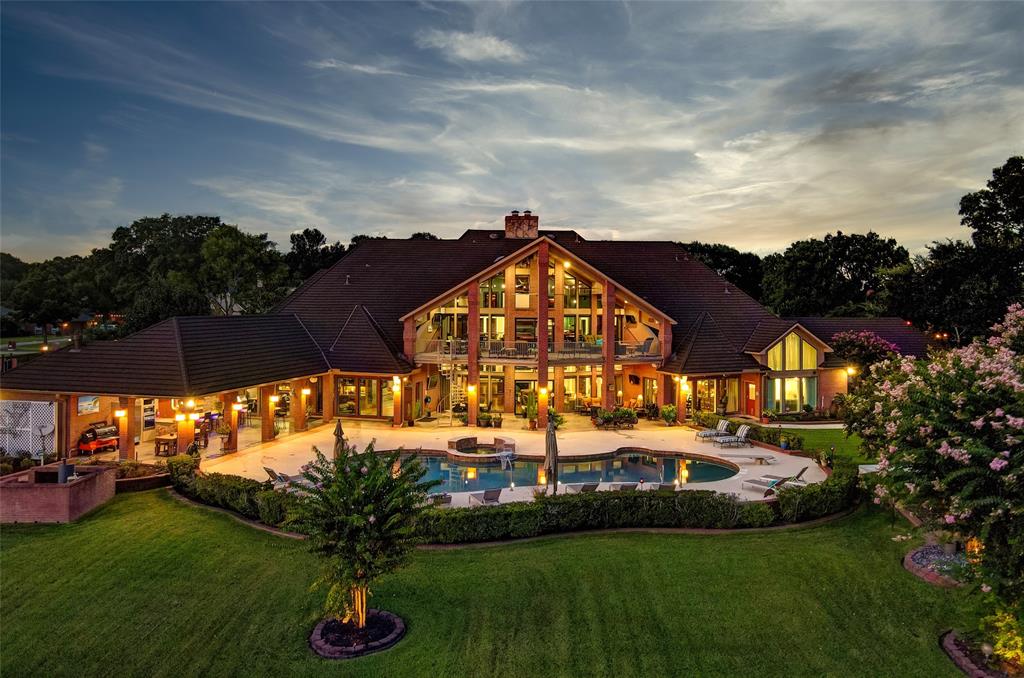 YOU WILL NOT WANT TO EVER LEAVE THIS SPECTACULAR ONE OF A KIND WATERFRONT ESTATE located on 4 waterfront lots(2.4 acres)w/480 FT bulk headed water frontage on LAKE CONROE! This gated estate consists of a 17k/SF primary residence w/guest suite, gym, spa, 2 boat houses W/full kitchens, 4 boat lifts, Porte-Cochere, Workshop, resort pool, outdoor kitchen, pristine landscaping, 2020 metal roof, commercial playground, raised garden w/irrigation. Additional outstanding feat, outdoor kitchen under covered deck providing year-round entertaining, elevator, heated floor tile, game room, media room, exercise room, dry & wet sauna in private spa, office, library, craft room w/built-ins, massive wine room, 8 BEDROOMS, 9 FULL & 3 HALF BATHS & 5 kitchens! Architectural details such as large archways, floor-to-ceiling windows, plentiful cabinetry & built-ins, high vaulted ceilings plus so much more!1000 characters just cannot describe the beauty & amenities this home has to offer. Ck out video&3D tour.