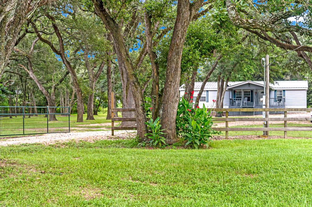 5647 W Fm 1093 Road Wallis, Texas Your great escape! Nestled on a beautifully wooded 1.5 acres this 3 bed/2 bath home is located less than an hour from Houston. The large covered porch attached to the front of the home and enormous deck right out the back door will give you plenty of room to sit and enjoy the peaceful country side. Mature oak trees are abundant throughout this property and provide tons of shade. The interior of the home will give you just as much peace and relaxation as the outdoors. Large bedrooms and closets are complimented with beautiful wood like floors, crown molding and a large kitchen. This home is perfect for a weekend get away or a permanent stay! With its proximity to Houston and low tax rate this unbelievably maintained property and home wont wait for you long!