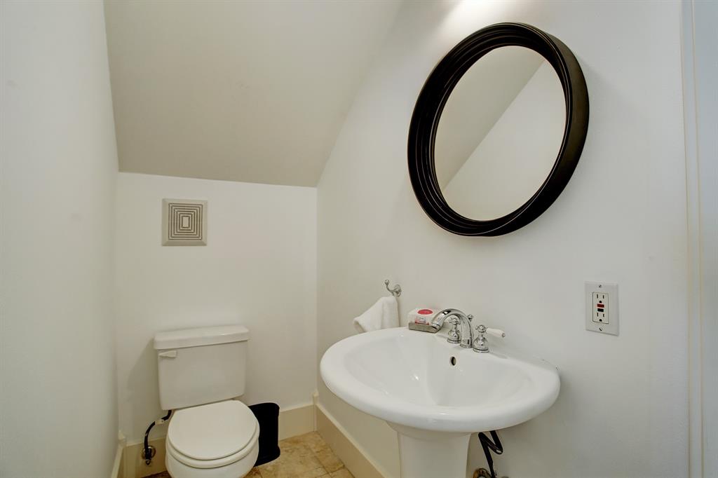 As mentioned earlier, the half bath on the first floor is located discreetly across from the coat closet in an alcove.