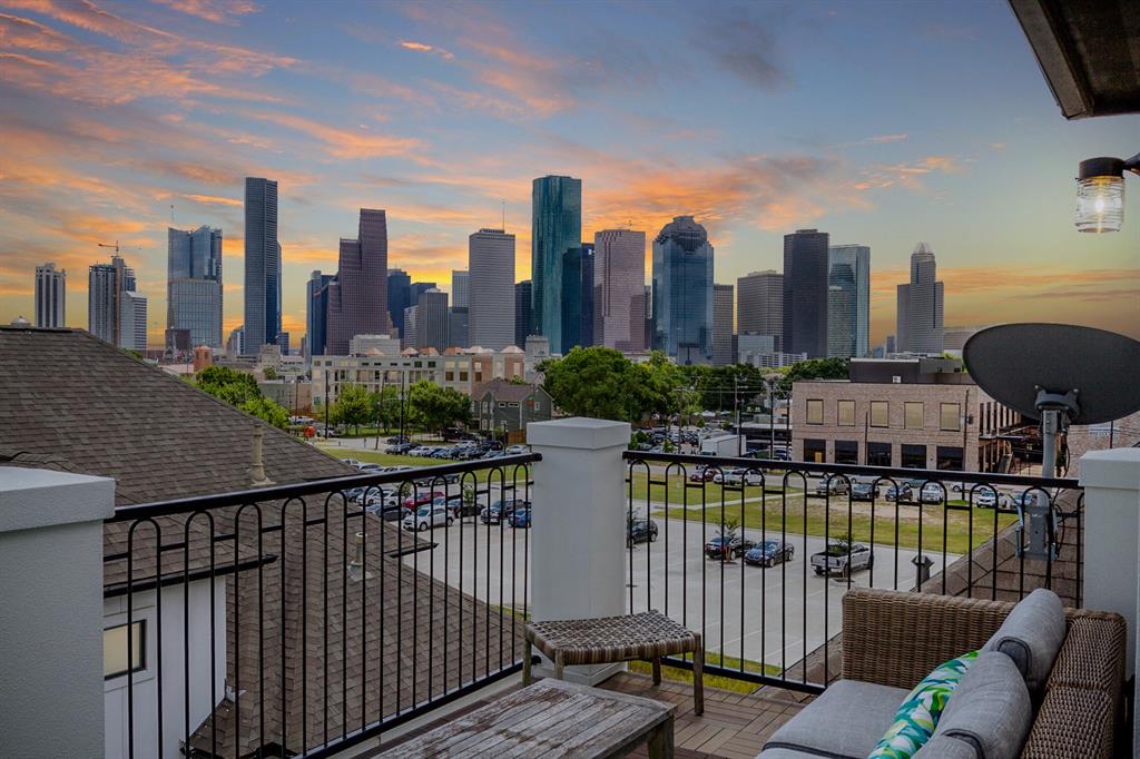 1877 Dart Street Houston, Texas Breathtaking skyline views await in this one-of-a-kind opportunity! With beauty around every corner, you'll fall in love with this exceptional 4-story home. Relax or entertain guests in a spacious open floorplan on the 2nd level. High ceilings, gorgeous wood floors, and a gas log fireplace create a welcoming living room atmosphere. Enjoy an elegant island kitchen that features spacious granite countertops, ample cabinet space, and warm natural light. Under-cabinet lighting and a stunning chandelier add beauty and sophistication. Retreat to a lovely primary bedroom on the 3rd floor that offers a serene bathroom and spacious walk-in closet. A second bedroom and full bath rest on the 3rd floor while a third bedroom and bath occupy the 1st-floor, perfect for guests! Delight in a 4th-floor study with access to a rooftop balcony. Enjoy captivating views of a sparkling skyline with a morning cup of coffee or relax with a glass of wine under the stars on this exceptional 4th-floor haven.