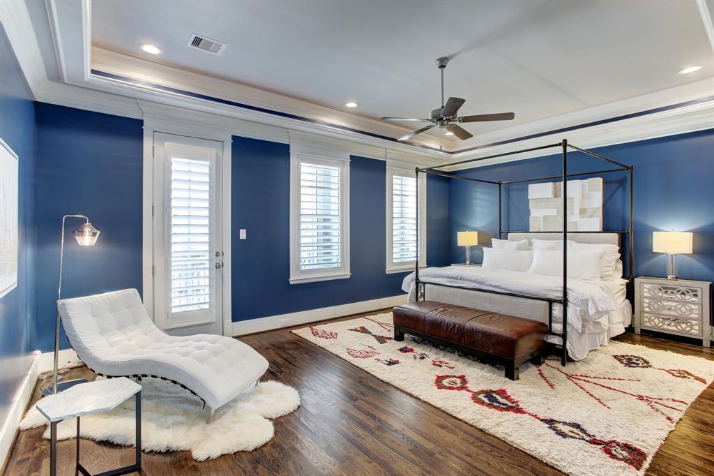 The very amply sized primary suite will not disappoint, with its tray ceiling as well as plenty of room for a king bed, generous nightstands, and lounging space.  The door to the left leads to a balcony at the front of the house.