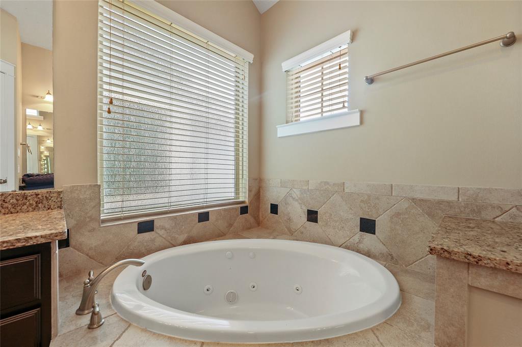 The primary bath also features a separate tub and shower.