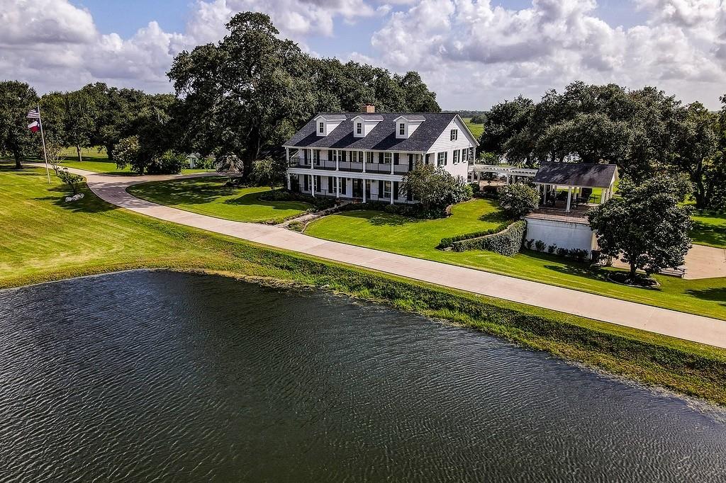 The Magnificent B Bar J Ranch is now on the market!This exquisite Louisiana Plantation Architecture blt in 2001. In 2017-2018, a total remodel took place.The estate is surrounded by 120.993 groomed acres and sits in a quiet panoramic ambiance of manicured grounds, and pool, framed by 200-300 year old oaks, mature pecan trees. 5  ponds, improved pastures,seasonal creeks.2 entrances: One dbl gated “B Bar J Ranch”, white pillars introduce a stately driveway that stretches 900 feet of concrete drive, the second entrance a few yards down is also a 900’ concrete drive to the main house that shares a circle drive,2 car Porte-Cochere. Kitchen and Butler's Pantry is state of the art, and just outstanding! (please see B BAR J Ranch Detail attachment) Primary Bdrm Dwn, 3 up + media rm each with balcony access.Exercise Facility, 150' x 150' Covered Open Air Arena, 800' Cowboy Bar that looks onto arena's competitions from Bar, Equipment Barn w/3 12 x 12 Horse Stalls, Please see attached Detail!