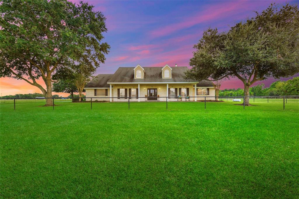1415 County Road 661 Dayton, Texas Your Country paradise awaits! Located just outside of Dayton Texas you will find this beautiful country estate tucked away in an idyllic setting just off a quiet county road. Through the sweeping gate, and down the long asphalt driveway the home you've dreamed of awaits. Resting quietly beneath the mature live oaks you will find the stunning traditional home boasting 5 bedrooms 3.5 baths with expansive rooms dimensions, stunning views from each window, and enough porch space to provide a family with a lifetime of memories overlooking the breathtaking tropical pool in the back or simply watching the cattle graze from the front porch. This beautifully updated country home sits on 39+/- acres of improved, and fully fenced pastures. A lighted arena is located on the property as well as two large barns/metal buildings, and home office. This country estate exemplifies the best in country living . First class set ups for horses, or show animals. Check out the video below.