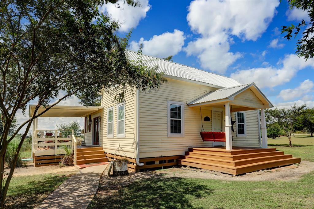5685 FM 1457 Round Top, Texas The 4 bedroom 1292 sf main Farmhouse comfortably sleeps 7 in 2 king beds, 2 twin beds and a full bed. This Farmhouse has 1.5 baths and a common gathering space with kitchenette and porches.
The 3 bedroom 1234 sf second Farmhouse sleeps 6 in 2 king beds and 1 queen bed. This Farmhouse has 2 baths and a common gathering space with kitchenette and porches.
The Barn is a charming 480 sf studio space with a queen bed, full bath and kitchenette with porches.
The metal building houses an extra refrigerator and washer/dryer for guest use.
All furnishings pictured, including the table top appliances, refrigerators, dishwashers, washer and dryers will convey.
The property is further enhanced with yard art, garden shed and storage chicken coop.
Don't miss the opportunity to own this enchanting Texas Farmhouse property - a Round Top treasure!