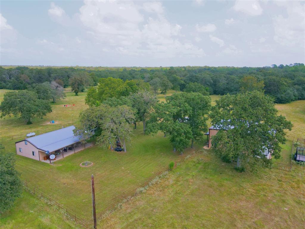 14614 CR 499 Normangee, Texas 47 acres of gorgeous hardwoods and pasture, right around the corner from Hilltop Lakes. Land is fenced and crossfenced. Very nice 2 bedroom, 1 bath metal home. There is also a large barndominium guest house/apartment on the property, working pens and storage building. This is a great property with a fabulous location! This property also includes a purchased lot in the Hilltop Lakes estates allowing for a country club membership. If you are looking for the country life with country club amenities this is your dream place!!!