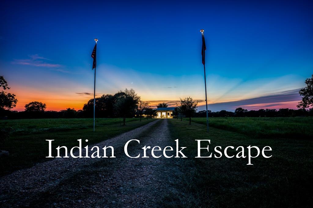 3600 Indian Creek Lane Brenham, Texas Indian Creek Escape sits nestled away on a quiet, country road just 15 mins from downtown Brenham. The home is set up with comfortable, country living in mind. Easy-to-maintian vinyl wood floors can be found throughout. The kitchen features an oversized pantry, solid hickory cabinets with drawer inserts and soft close hardware as well as granite countertops and a gas range. The oversized back porch is a perfect place to sit with a glass of wine and watch the sunset as the deer travel between feeders at the bottom of the pasture
Attached to the house are 3 oversized bays, each with a pull through including one with a 14 ft door and 30 amp hookup especially for RVs. A workshop can be found just on the other side of the garage and provides ample storage
The land itself is made up of mostly improved pasture, making an ag exemption simple to maintain through hay production. The pond, flanked by willows and other trees, sits towards the back of the property and is stocked with catfish
