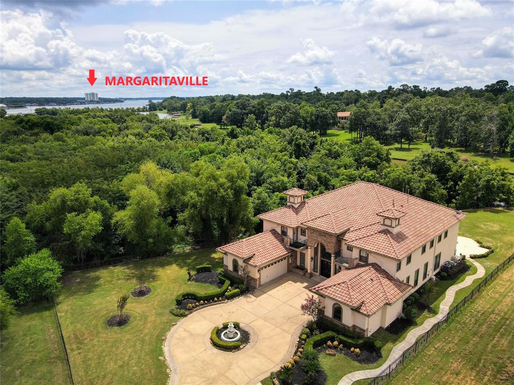 11503 Renaissance Drive Montgomery, Texas Gorgeous 7700 + SF WATERFRONT Custom Home on almost 3/4 of an acre. Very PRIVATE Cul-De-Sac Estate! Take in Beautiful Lake Views through Grand Dual Staircases with an Impressive 2 Story Foyer, Endless Custom Features, 7 Oversized Bedrooms & 6 1/2 Baths, 4 Car Garage with circle driveway, Large Open Chef's Kitchen with Bosch Appliances & built in Refrigerator, Granite countertops, 2 Kitchens, Study, Open Floor Plan with 3 Living areas & expansive windows taking in the Outdoor Oasis & Lake Views, perfect for Entertaining & surrounded by Serene Outdoor features with a Pool & Spa in Gated Grand Harbor Community, Low Taxes, Close to Margaritaville, Shopping & Restaurants in highly sought after Montgomery ISD.