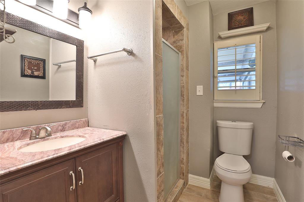 second bathroom with remodeled, tile shower.