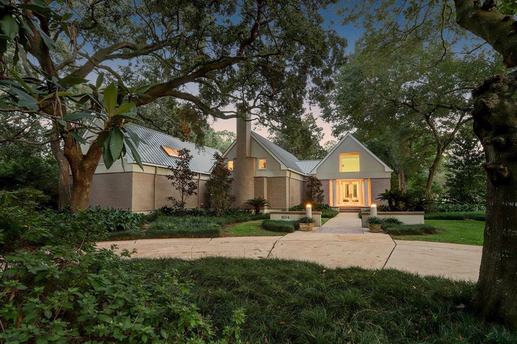 Situated on a prime corner in the heart of Tanglewood, this soft contemporary stucco/brick residence was designed by architect Robert Griffin for the present owner. The 3 bed/5.5 bath home is set back on the 58,963+/- sq ft lot w/ front yard circle drive w/ massive oak trees & expansive back yard lush w/ multiple trees & overhanging canopies, pool w/ Pebble Tec finish, hot tub & water feature, covered gazebo & stone walkways interspersed between numerous garden areas. A double glass door entry leads to a spacious 2-story Living Room, comfortably sized Library w/ fireplace, spacious Primary Suite w/ dual baths, 2nd floor Study, stately Dining Room, well-organized Kitchen & cozy Breakfast area, large Family Room w/ Wet Bar, Guest Bedroom w/ en suite bath & second Guest Suite presently used as Exercise Room w/ full bath. Custom millwork throughout, hardwood flooring, floor to ceiling windows, Kohler generator, & mosquito misting system are only a few of the home's fabulous appointments.