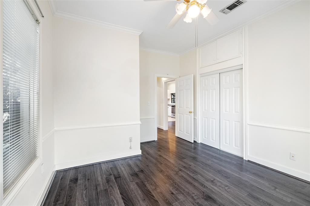 One of two bedrooms  with updated flooring, generous closet space, and a ceiling fan.