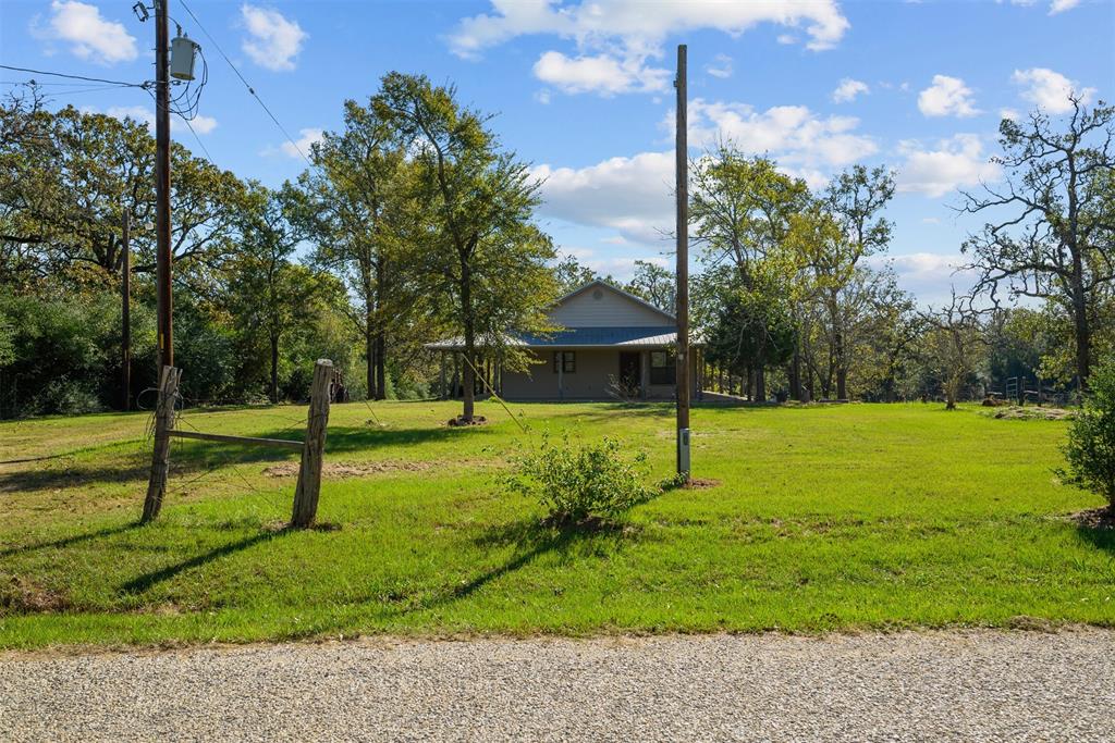 10 +/- wooded acres with a welcoming country home in Bryan, TX. Come home to the views of pure serenity. The property is partially fenced with a large pond and loafing shed. This precious home is 1,470 SQFT, 3 Bed/2 Full Baths. The open kitchen/living combo is spacious with tons of counter space and lots of cabinets for storage. The livingroom has tall ceilings and large windows that invite the natural sunlight. There is a wood burning fireplace in the corner of the living area. Large laundry room! The wrap around porches make the evenings great for watching the wildlife that surrounds the property. This property is a MUST SEE.