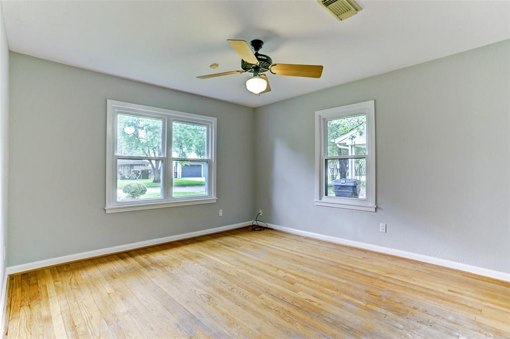 Third bedroom with ceiling fan and natural light