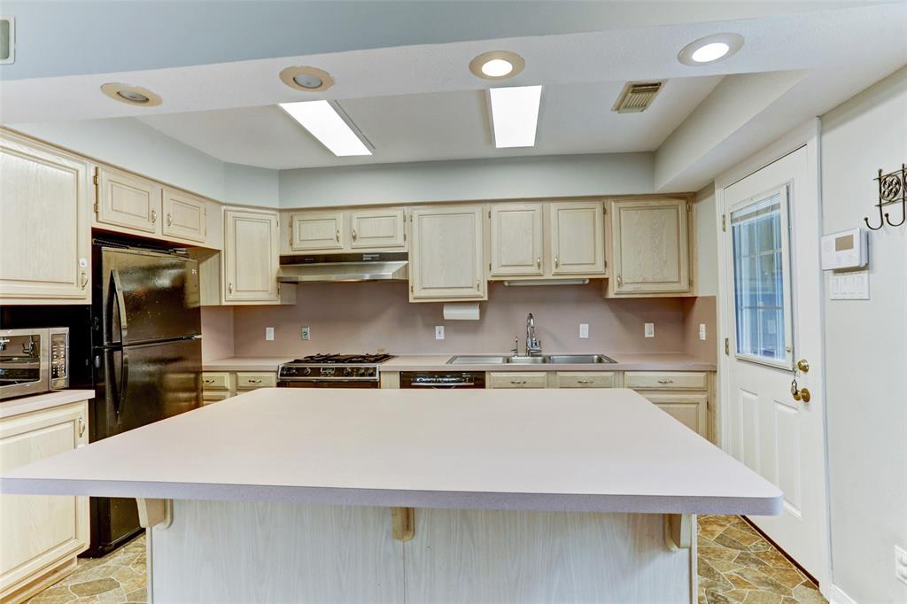 Useful kitchen with island. Refrigerator comes with house.