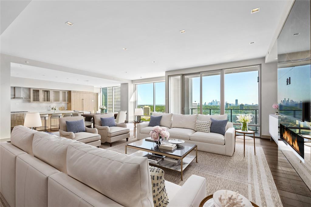 This graciously proportioned, 3,561 sq. ft. penthouse is designed for modern living on a grand scale. Shown here are the large living room & kitchen with breathtaking downtown views.