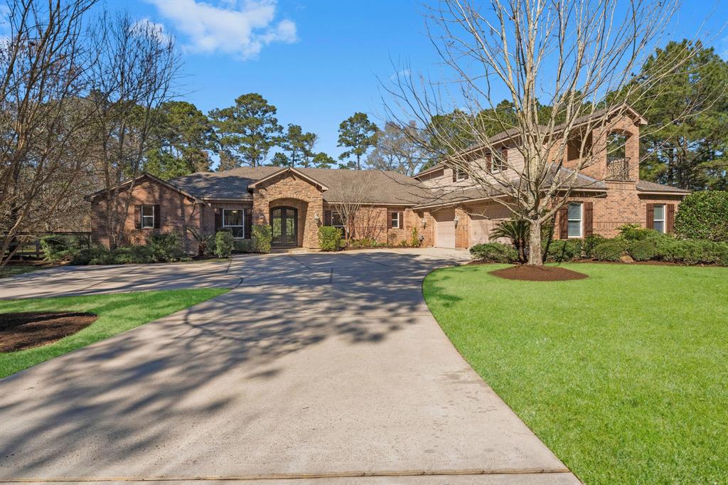 Stunning custom home located in golf course & acreage community of Lake Windcrest just minutes from The Woodlands. Featuring high end upgrades the property is beautifully sited on private 2 AC cul-de-sac lot. Entry is adorned by heavy Cantera double doors showcasing panoramic view of backyard oasis. The open floor plan lives like a 1.5 story w/wide doorways for wheelchair access. 1st floor features primary suite w/ lux bath, 2 bedrooms each with PR baths & study w/closet(optional 5th bedroom) LG guest suite up w/ full bath, huge gameroom, wet bar & balcony. The primary suite is accented with w/luxe bath & huge closet w/ custom built in’s. You will love the sprawling family room open to gourmet kitchen w/custom cabinetry, exotic granite counters + new built-in Sub Zero fridge. Pool, covered patio w/ built in counter & sink, oversized 3 car garage, tankless water heater, LG shed, whole-house generator + NEW ROOF augment the many special features of this estate like home!