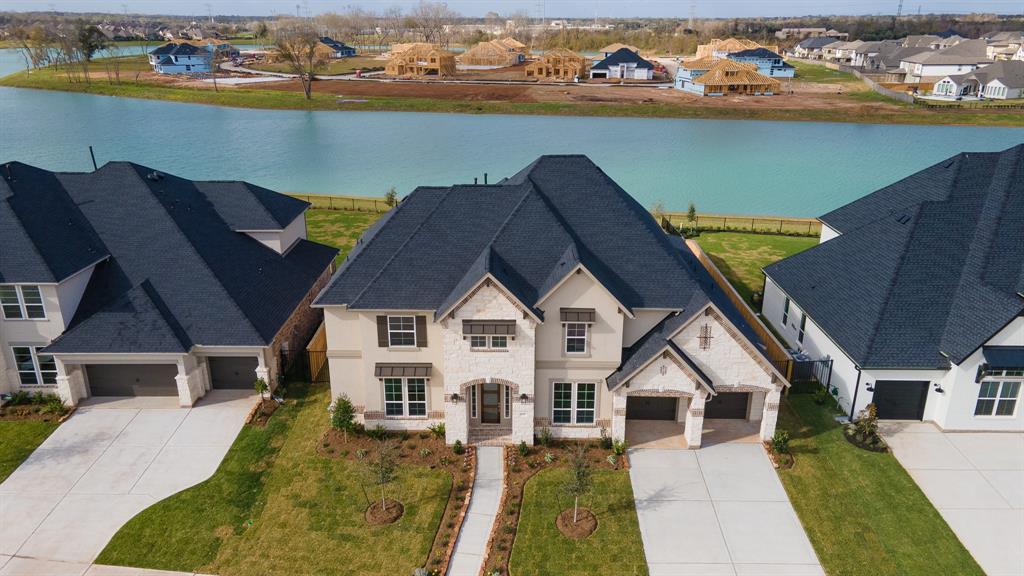 NEW CONSTRUCTION HOME ON 80' LAKE LOT JUST UNDER A MILL! This STUNNING LAKEFRONT 2 Story Home offers 5 Beds, 4.5 Baths, 2 BEDS DOWN, & HAS NEVER BEEN LIVED IN! Upon arrival greeted by the Formal Foyer w/soaring ceilings & tile flooring that flows through 1st level living spaces, Dedicated Dining Room for entertaining & Sophisticated Study. Luxurious Living Room w/soaring ceilings, wall of windows, & fabulous fireplace to cozy up to. Gourmet Kitchen boasts granite countertops, Breakfast Bar for additional seating, pendant lighting, tile backsplash, & under cabinet lighting! Breakfast Area to enjoy meals together. Game Room upstairs with additional room for a FLEX space, great for Media Room or Second Study. Spacious secondary bedrooms! Covered Patio out back w/abundance of greenspace to enjoy & serene lake view. Situated in the heart of the exclusive section of Sawmill Lake in Sienna w/+ amenities such as park, pool, clubhouse & volleyball court! Zoned to FBISD & near shopping/dining!