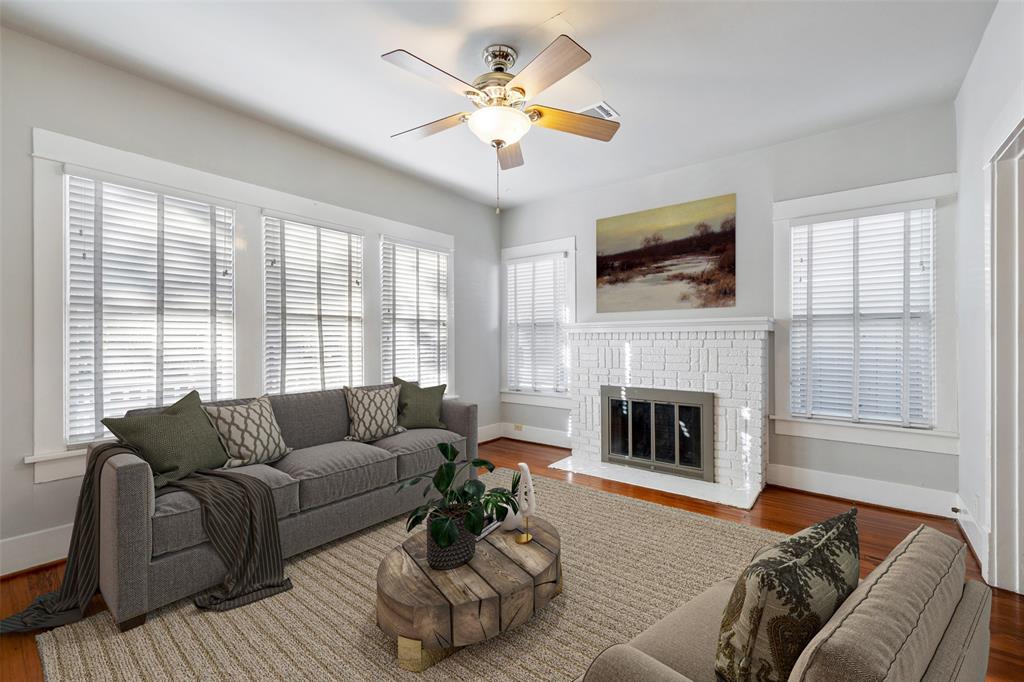 The living room features wood floors, lots of natural light and neutral colors.  This photo has been virtually staged.