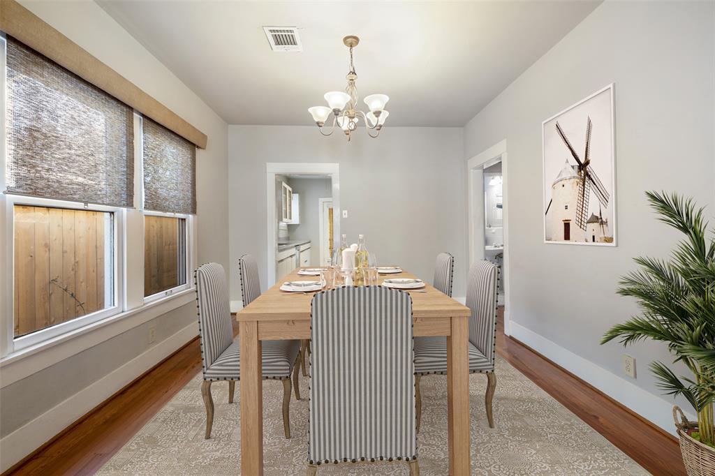 The dining room can easily fit a six person dining table and features wood floors.  This photo has been virtually staged.