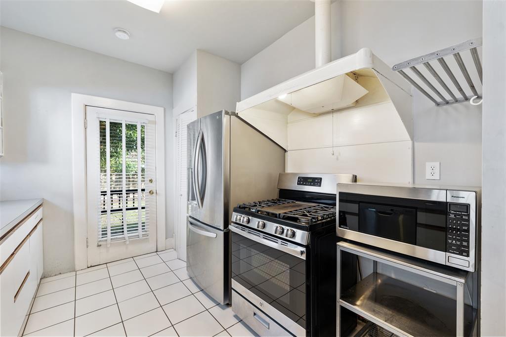The kitchen features stainless steel appliances and has easy access to the back yard and deck.