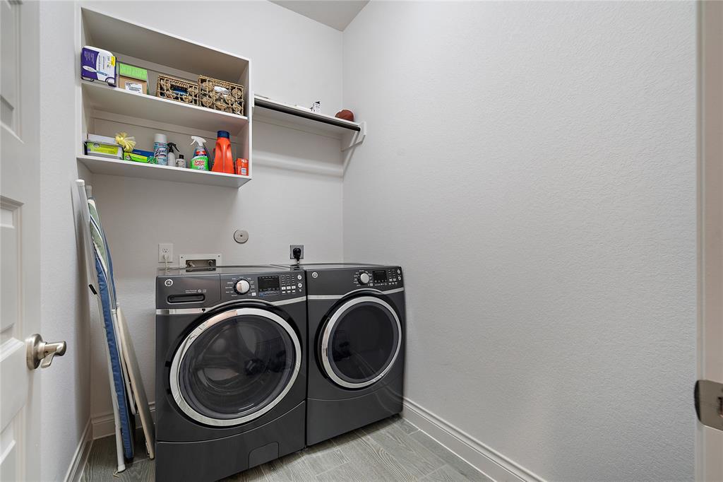 Utility room off main walkway with modern energy efficient appliances.