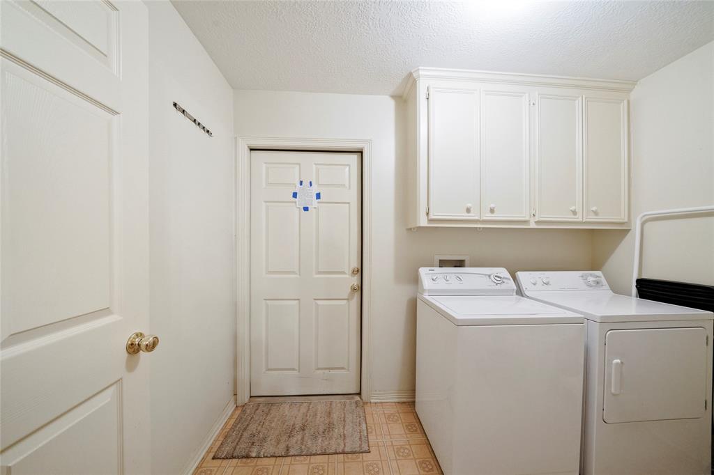 Large utility and mudroom located just off the garage and inside the home.