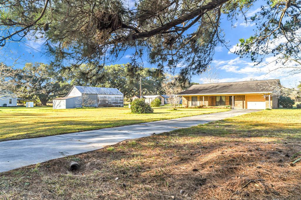 This stunning 12 acre property features two homes (a 1900 cottage which was remodeled in 1996 & a brick ranch style built in 1986) The property features a barn, storage shed, pond and 1 additional non-livable cottage. Gorgeous 100+ year old oaks on the property. Build your dream family compound or a sprawling estate home. 2 acres of homestead and 10 acres of ag exempt property.