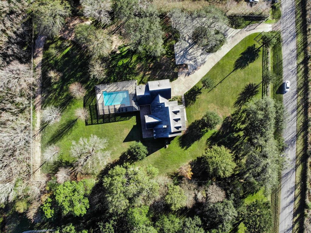 Very rare opportunity to own a custom-built with land. This beautiful home in Katy on 2 acres is breathtaking with wooded trees & surrounded by nature. This private 2-story estate offers a serene environment perfect for tranquility while just minutes away from nearby shopping & restaurants and New Katy ISD
schools. Abundant kitchen w/a wide-open concept, tons of storage, huge center island, beautiful subway tile backsplash and stainless steel appl, custom cabinetry. Primary suite w/expansive windows overlooking the wooded scenery and solar screen covered pool that will definitely be perfect for entertaining. Two bedrooms are located on the opposite side of the house. Upstairs offers 2 bonus rooms, one currently used as an office overlooking the living room. The second room can be used as an add bedroom suite or family game room with its own full bathroom.  The phenomenal outdoor entertaining  Home has been updated and has an absolutely gorgeous layout and boasts with elegance.