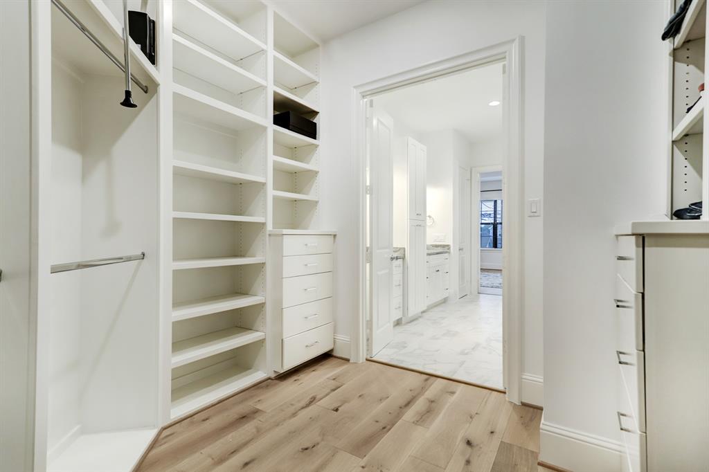 Roomy, useful, attractive primary closet with a custom closet system.