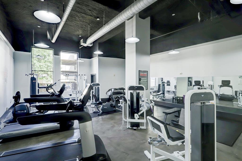 Full gym including an assortment of exercise machines and weights.