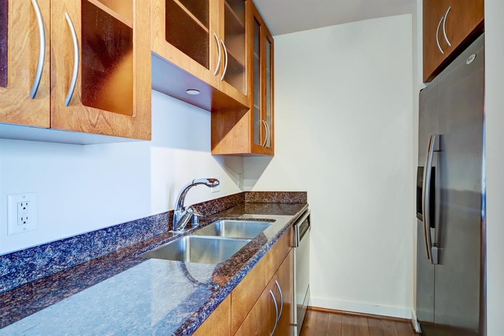 Beautiful wood cabinetry and granite countertops with helpful storage and stainless steel appliances.