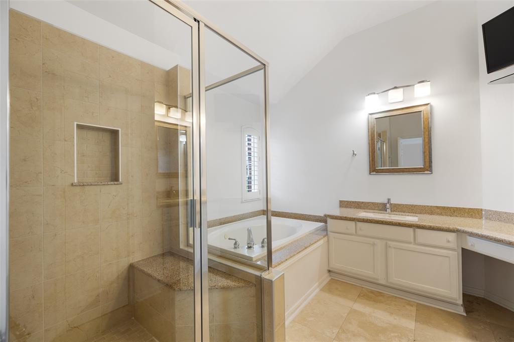 The primary bath features updated tile and granite counter tops.