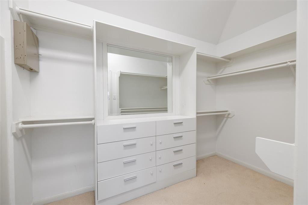 The primary suite features a walk-in closet with built-in storage.