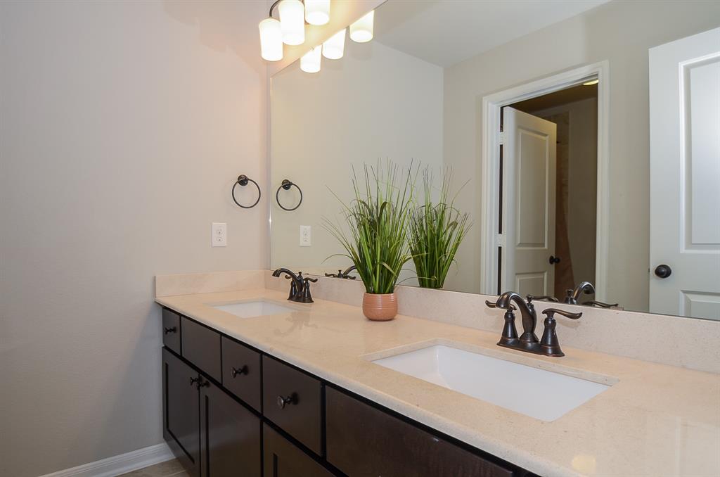 double sinks, granite counter, & lots of lighting