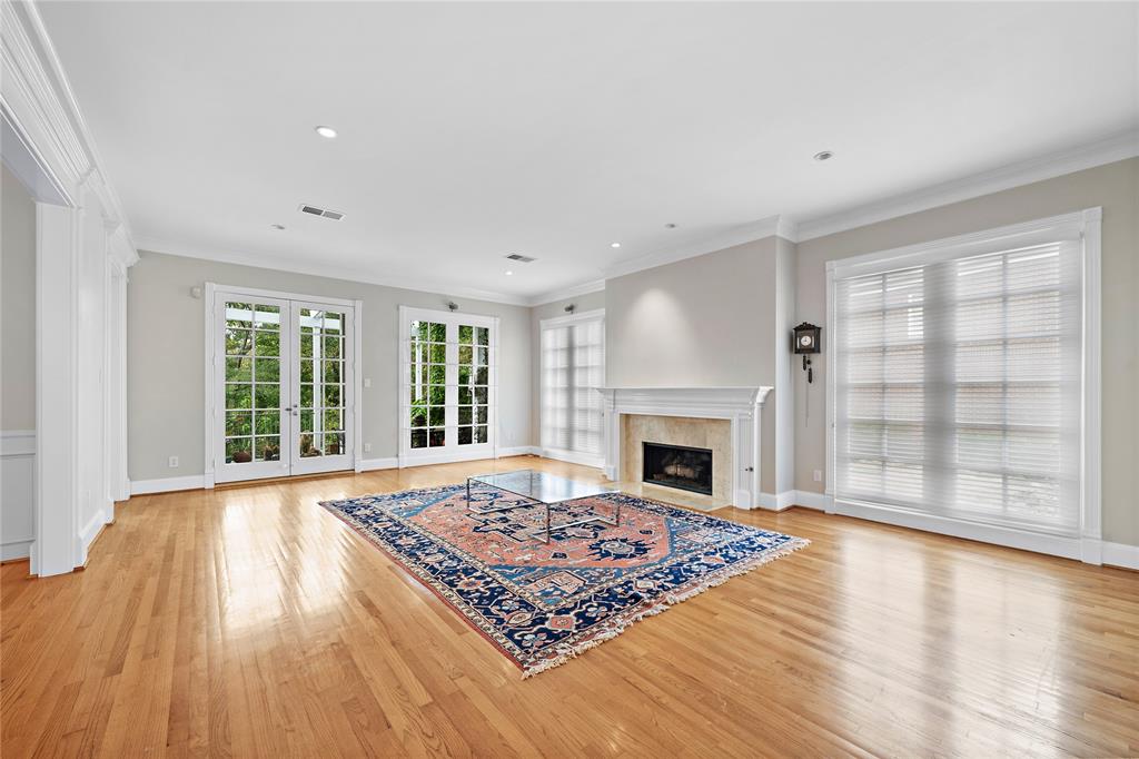 Spacious formal living with generous natural light and fireplace.