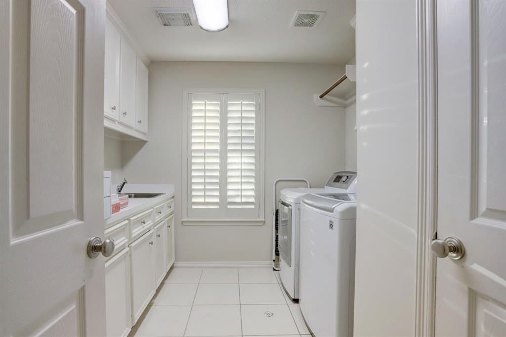 Large utility room with storage, counter space, a sink and a place to hang your clothes.