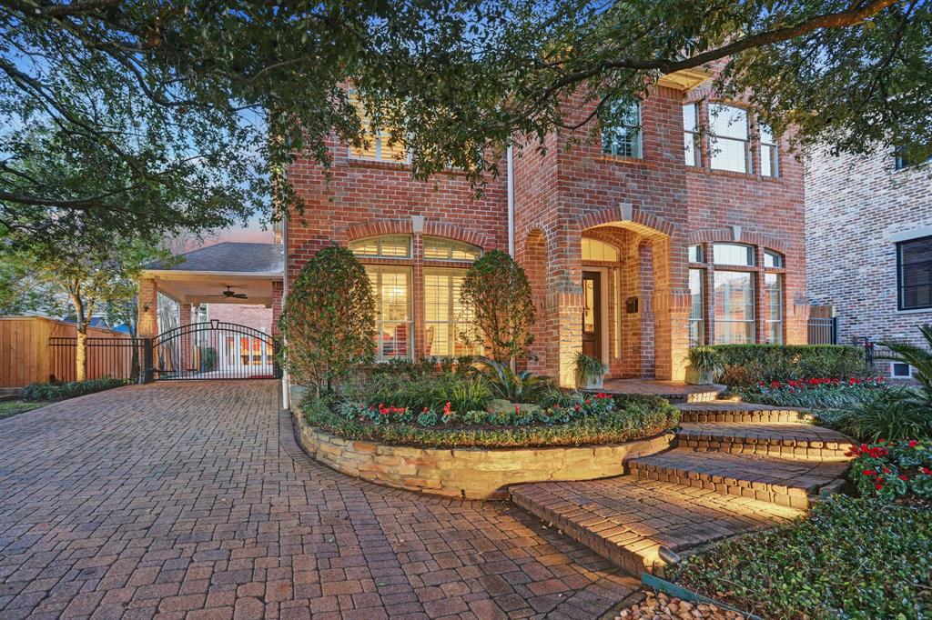 This home has curb appeal with its extensive landscaping and lighting.